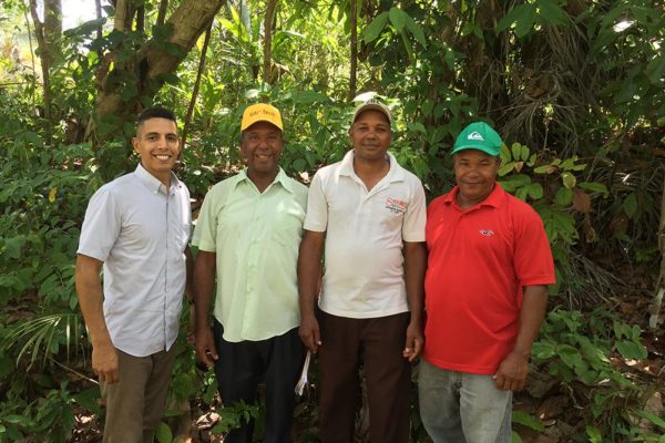 Dominican farmers and Peace Corps volunteer